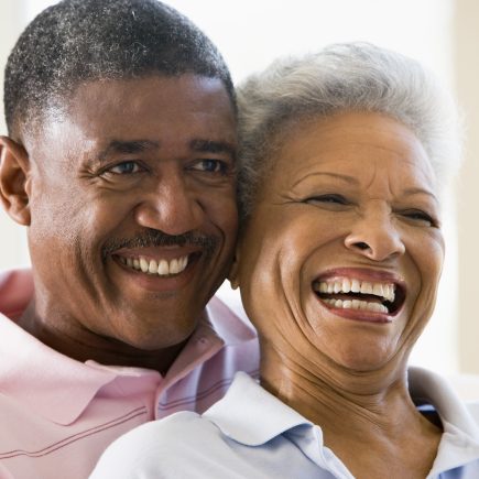 Older couple sharing a lighthearted, intimate moment in retirement