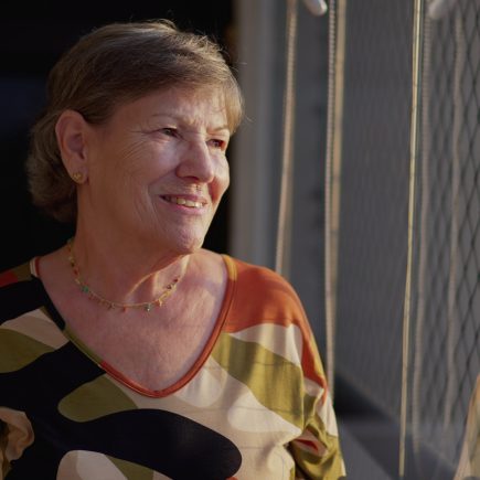 Confident retired woman smiling while walking outdoors, radiating energy and clarity