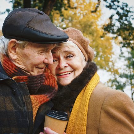 Happy retired couple walking avoiding common retired couples mistakes