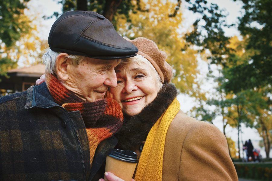 Happy retired couple walking avoiding common retired couples mistakes