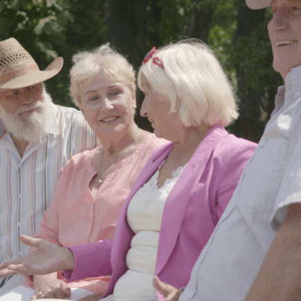 Group of retirees laughing together during a morning walk
