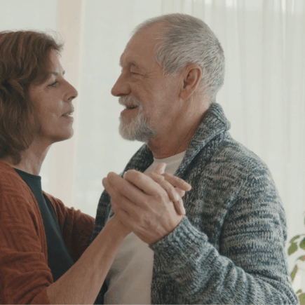 a happy couple dancing after avoiding retirement drift