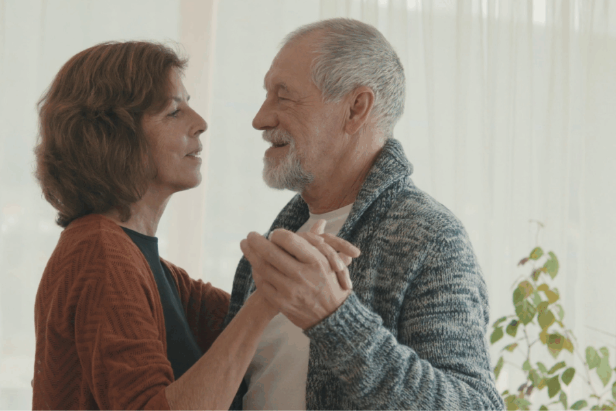 a happy couple dancing after avoiding retirement drift