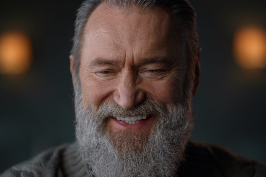 Older man smiling warmly, representing the joy and freedom of breaking old habits in retirement