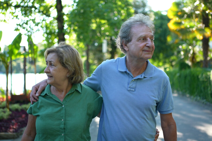 Retired couple walking on a nature path, symbolizing a clear and purposeful retirement journey