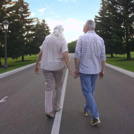 Retired couple walking hand in hand, reflecting on how retirement changes marriage.