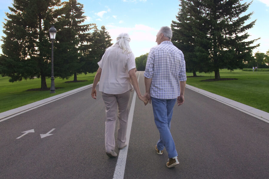 Retired couple walking hand in hand, reflecting on how retirement changes marriage.