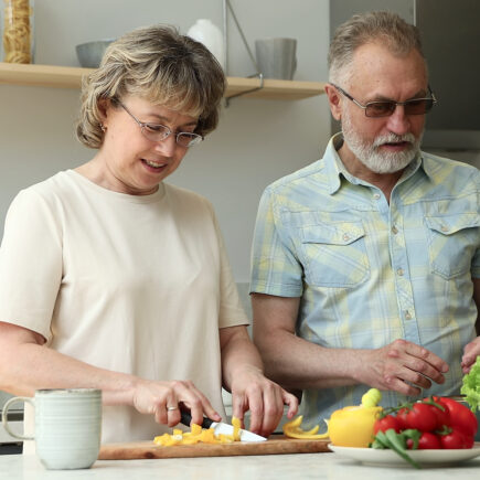 Retired couple walking outside during an evening sunset, reconnecting and enjoying peaceful time together.