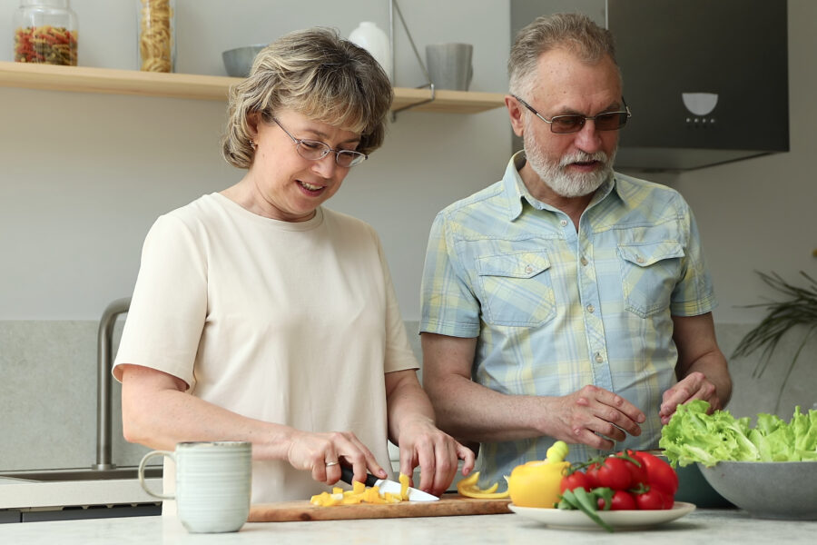 Retired couple walking outside during an evening sunset, reconnecting and enjoying peaceful time together.