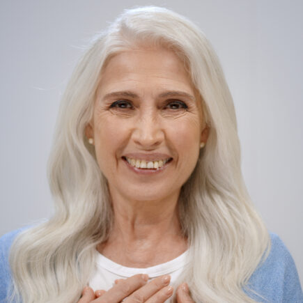 Woman smiling confidently as she reflects on life after 60.
