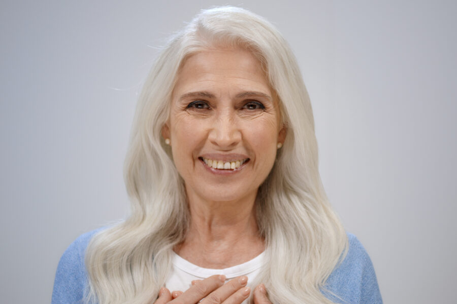 Woman smiling confidently as she reflects on life after 60.